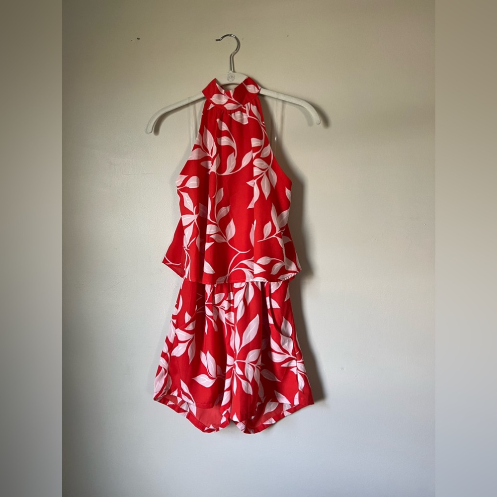 Halter romper in red and white leaf pattern with pockets. Size Medium